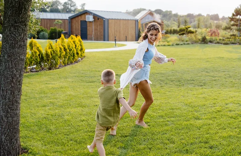 mother and son running in backyard